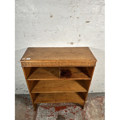 216 - An early 20th century carved oak bookcase - approx. 96cm high x 78cm wide x 30cm deep