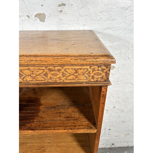 216 - An early 20th century carved oak bookcase - approx. 96cm high x 78cm wide x 30cm deep