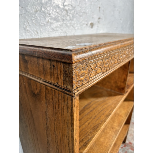 216 - An early 20th century carved oak bookcase - approx. 96cm high x 78cm wide x 30cm deep