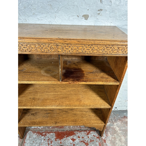 216 - An early 20th century carved oak bookcase - approx. 96cm high x 78cm wide x 30cm deep