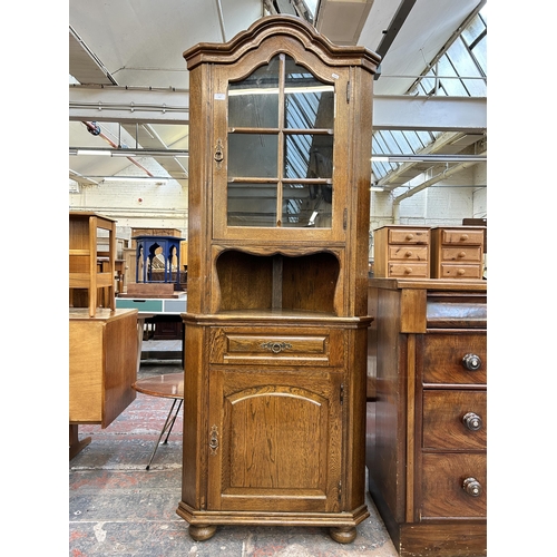 217 - An oak free standing corner cabinet