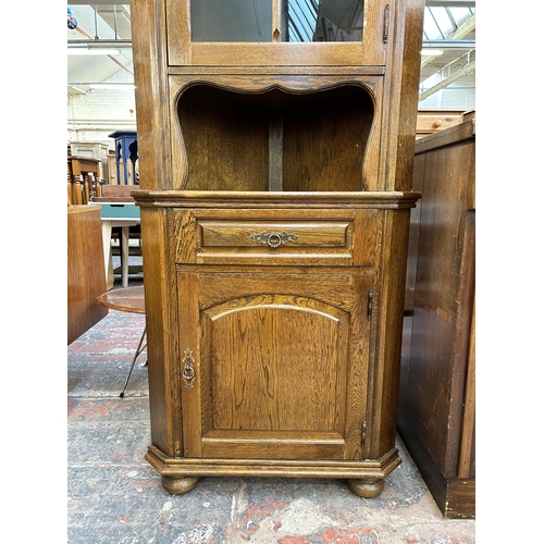 217 - An oak free standing corner cabinet