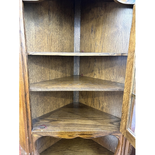 217 - An oak free standing corner cabinet