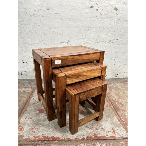 218 - An Indian sheesham wood nest of tables - approx. 45cm high x 45cm wide x 30cm deep