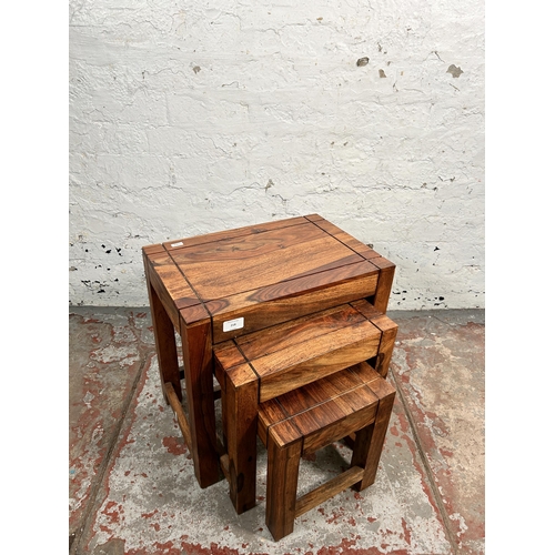 218 - An Indian sheesham wood nest of tables - approx. 45cm high x 45cm wide x 30cm deep