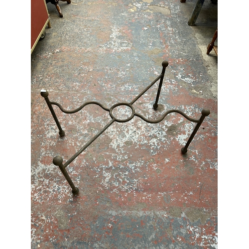 232 - Four blacksmith made wrought iron table bases - largest approx. 43cm high x 53cm wide x 102cm long