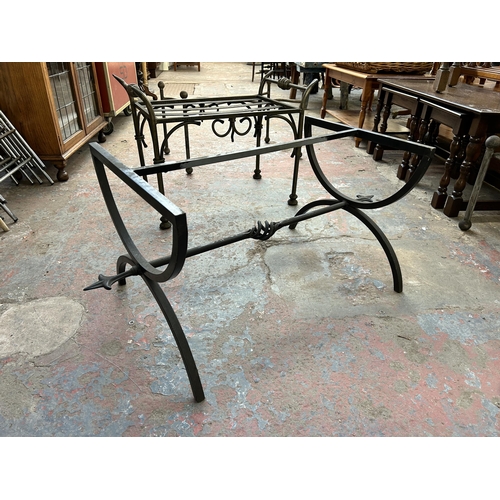 232 - Four blacksmith made wrought iron table bases - largest approx. 43cm high x 53cm wide x 102cm long