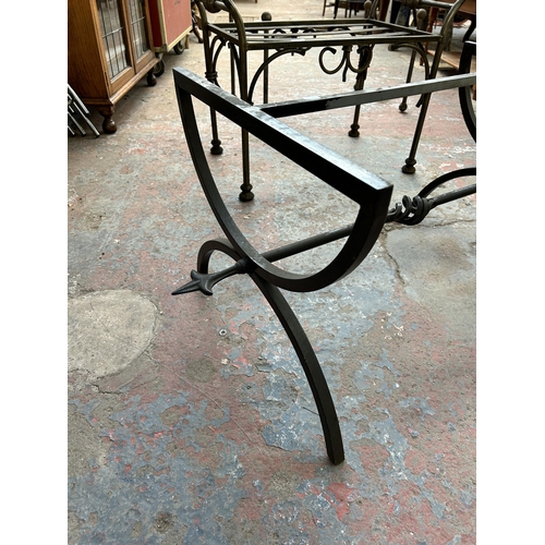 232 - Four blacksmith made wrought iron table bases - largest approx. 43cm high x 53cm wide x 102cm long