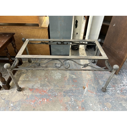 232 - Four blacksmith made wrought iron table bases - largest approx. 43cm high x 53cm wide x 102cm long