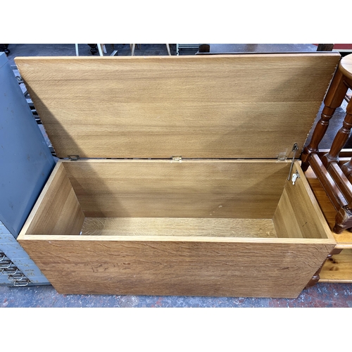 238 - A modern oak blanket box - approx. 50cm high x 107cm wide x 43cm deep