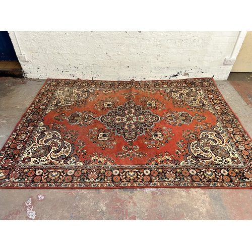 240 - A red floral pattern rug