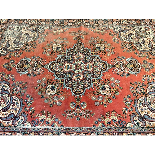 240 - A red floral pattern rug