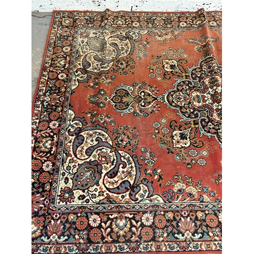 240 - A red floral pattern rug