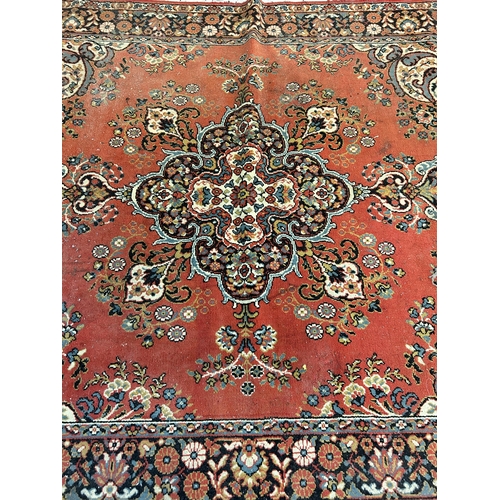 240 - A red floral pattern rug