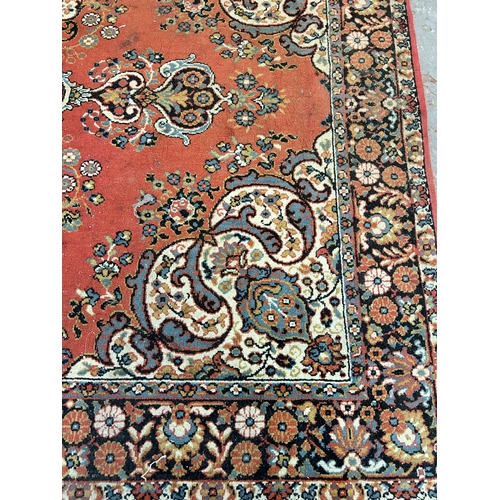 240 - A red floral pattern rug