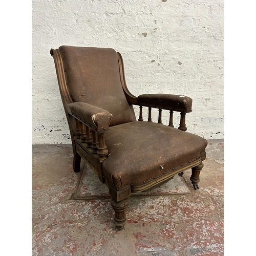 242 - A Victorian oak and brown vinyl upholstered parlour chair