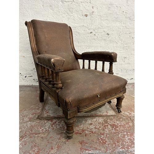 242 - A Victorian oak and brown vinyl upholstered parlour chair