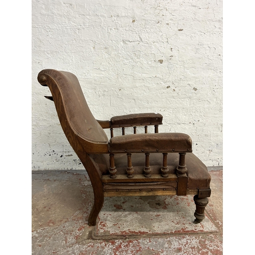 242 - A Victorian oak and brown vinyl upholstered parlour chair