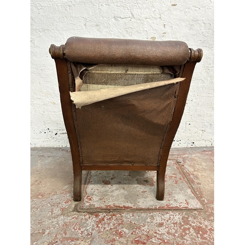 242 - A Victorian oak and brown vinyl upholstered parlour chair