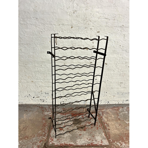 243 - A wrought iron bottle rack - approx. 120cm high x 61cm wide x 28cm deep