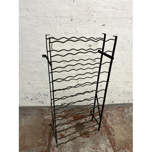 243 - A wrought iron bottle rack - approx. 120cm high x 61cm wide x 28cm deep