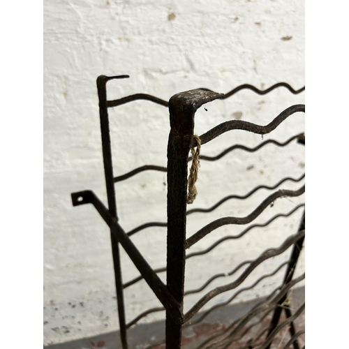 243 - A wrought iron bottle rack - approx. 120cm high x 61cm wide x 28cm deep