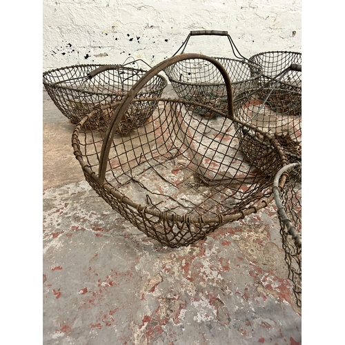 245 - Thirteen items, eleven vintage metal wire potato baskets, one galvanized bucket and one galvanized f... 