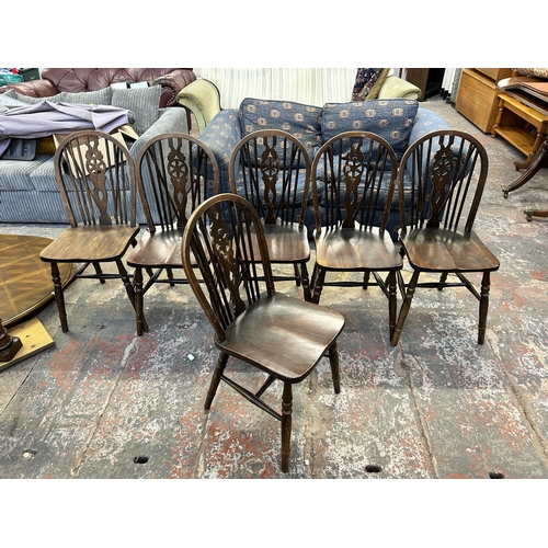 247 - Six beech wheel back dining chairs