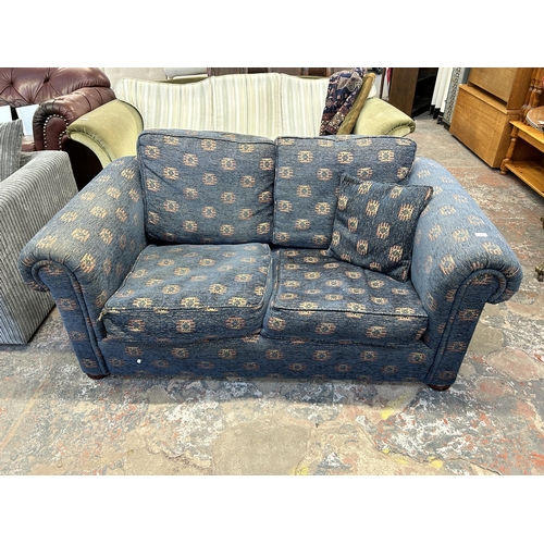 248 - A blue fabric upholstered two seater sofa