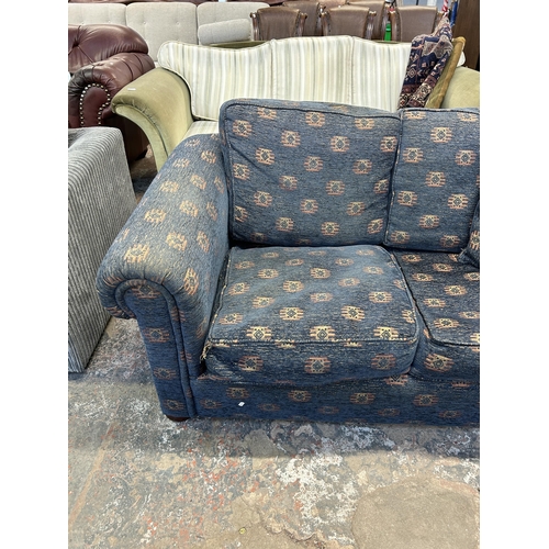 248 - A blue fabric upholstered two seater sofa