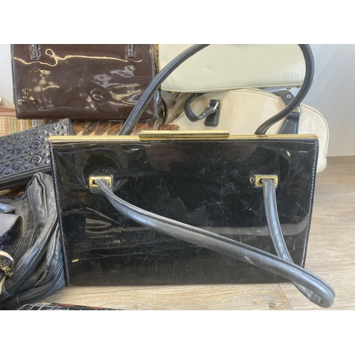 566 - A collection of leather ladies handbags to include vintage snakeskin etc.