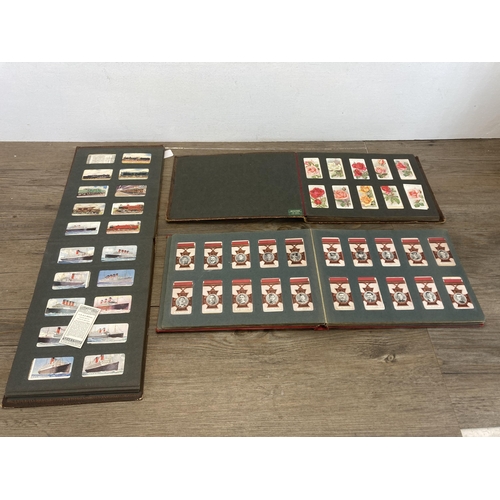 573 - Three vintage cigarette card albums containing a large collection of cigarette cards to include Will... 