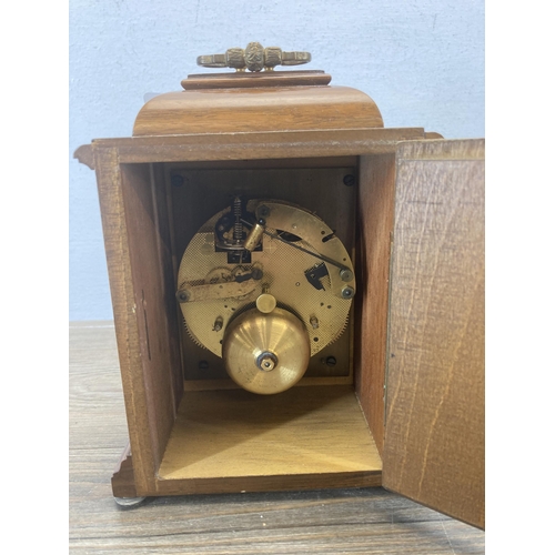 618 - A Thwaites & Reed walnut cased mantel clock with key