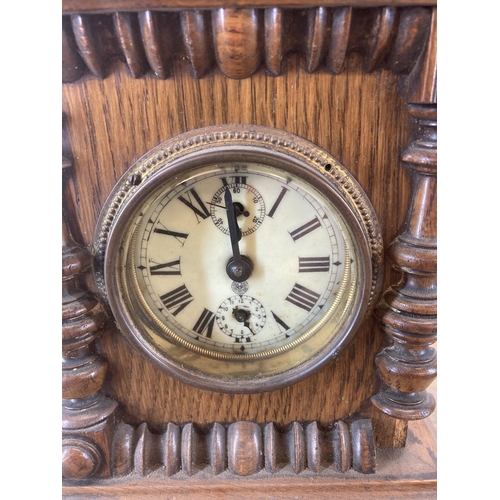 620 - An antique German oak cased mantel clock