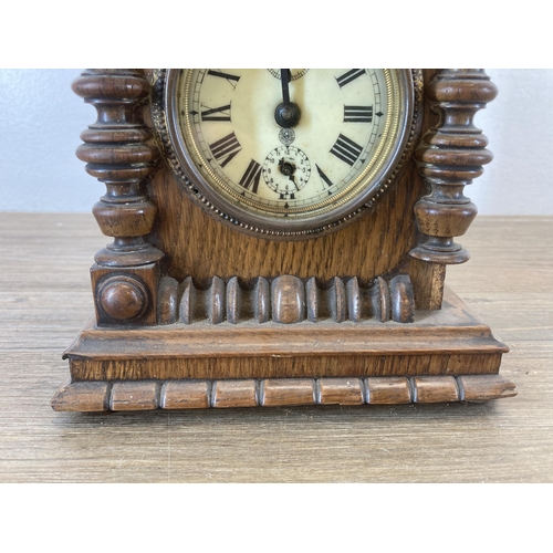 620 - An antique German oak cased mantel clock