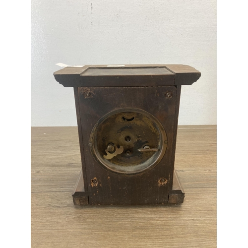 620 - An antique German oak cased mantel clock