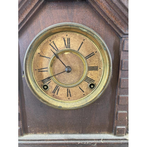 623 - An early 20th century Ansonia Clock Co. heavily carved mahogany cased chiming mantel clock