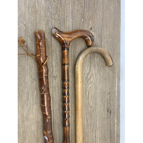 631 - A collection of vintage and later walking sticks