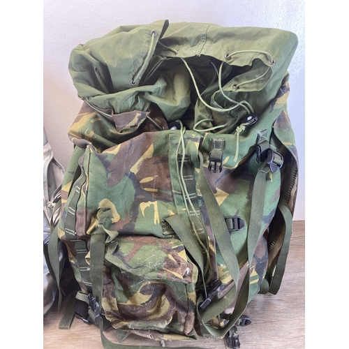 633 - Two rucksacks to include woodland camo etc.