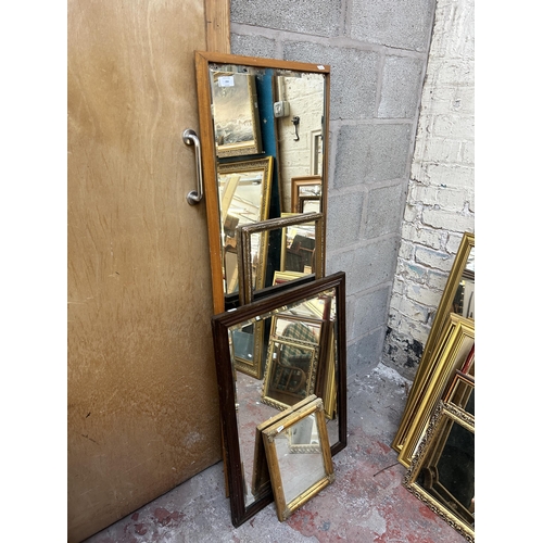 259 - Four framed wall mirrors, two gilt and two wooden - largest approx. 135cm x 44cm