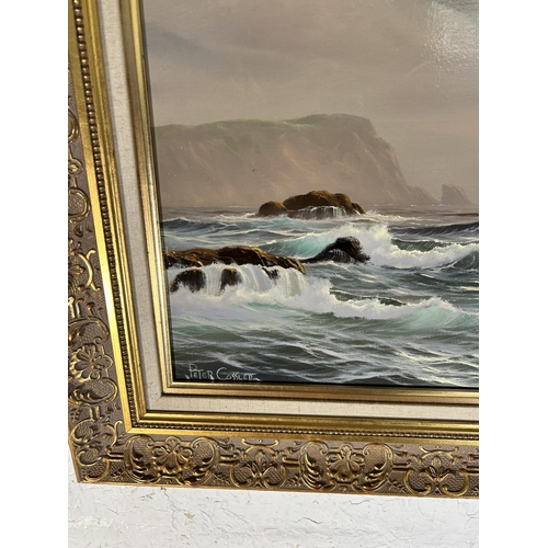 262 - A gilt framed Peter Cosslett (1927 - 2012) oil on canvas of a seascape - approx. 54cm high x 64cm wi... 