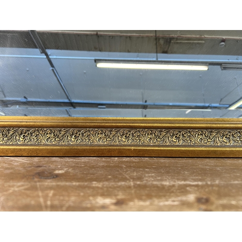 263 - A gilt framed bevelled edge wall mirror - approx. 91cm high x 117cm wide