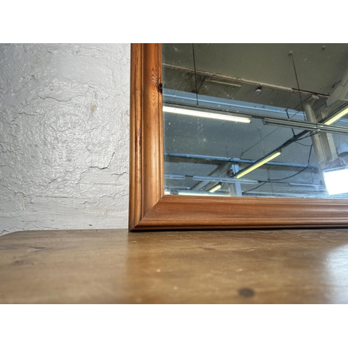 265 - A pine framed wall mirror - approx. 107cm high x 135cm wide