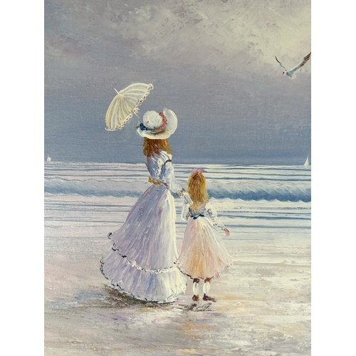 267 - A 20th century mahogany framed oil on canvas of a lady and girl on beach signed lower right - approx... 