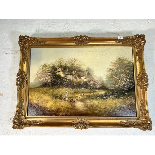 289 - A gilt framed Les Parson thatched cottage scene oil on canvas - approx. 64cm high x 90cm wide