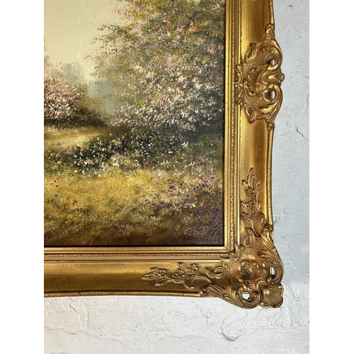 289 - A gilt framed Les Parson thatched cottage scene oil on canvas - approx. 64cm high x 90cm wide