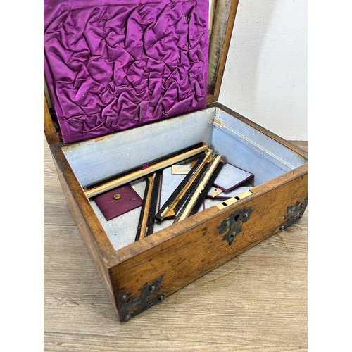 648 - A 19th century walnut and metal bound storage box