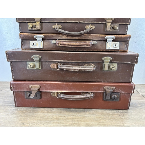 669 - Four vintage leather suitcases containing assorted masonic regalia