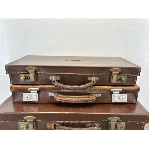 669 - Four vintage leather suitcases containing assorted masonic regalia