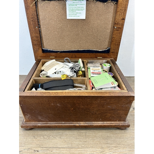 671 - A Victorian style beech and upholstered sewing box containing a collection of sewing accessories